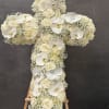 Elegant white funeral cross adorned with delicate white Phalaenopsis orchids &mdash; a