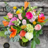 Bright and uplifting boquet of spring colors in glass vase 