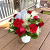 - 6 Red Roses
- 4 Red Carnations
- White Cushions
- Green Hypericum