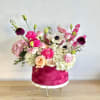 Burgundy velvet box with peach, white, and pink flowers. A delicate and
