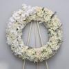 This white wreath is made with all white florals and features white