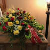 The Golden Tribute Casket Spray is a radiant display of love and