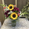 The colorful arrangement gives a bold statement sunflowers leading the way. 