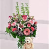 Girl color flowers arranged in a vase with a balloon and Teddy