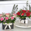 Mixed flowers in small handbag box.