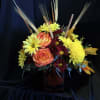 This bright bouquet includes yellow cushion spray chrysanthemums, bi-color orange roses, rust