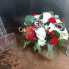 Assorted red and white flowers and pine. 
Roses, carnations, pom poms