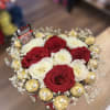 Red and white roses accompanied with chocolates