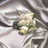Our florists hand-craft a gorgeous white rose corsage accented with fresh greens