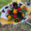 Designer's Choice with roses and Marigolds Halloween theme paper wrapped bouquet 