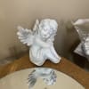 White resin wood carved angel figurine. Wrapped for home. Bows for services.