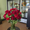 An elegant blend of velvety red roses and vivid red carnations, complemented