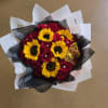 A beautiful mix of red roses and bright yellow sunflowers for any