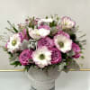 A serene blend of lilac roses, white anemones, and soft silver foliage