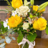 A vibrant bouquet combining roses, daisies, and sunflowers.