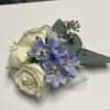 Pure and elegant, this corsage features fresh white blooms accented with soft
