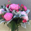 Glass vase with a pink spray roses and 5 pink peony&#039;s arranged