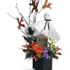 Boo! A googly-eyed ghost guards a graveyard garden in this fun Halloween