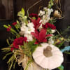 White ceramic pumpkin with fresh burgundy and white flowers, How Elegant!
*Flowers may