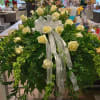Lush greenery with bellsof ireland, italian ruscus, and ivory roses make this