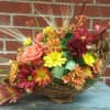 Beautiful fall cornucopia is filled with long lasting flowers perfect for a