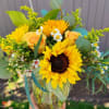 Beautiful  centerpiece designed with beautiful  sunflowers,  roses, sunny solidago
