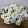 IN A CLEAR GLASS VASE COMBINATION OF WHITE hydrangeas ranunculus lisiantos 