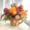 A vibrant fall arrangement featuring a variety of seasonal blooms in fall