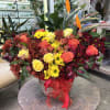This hatbox features exotic birds of paradise paired with roses, chrysanthemums, and