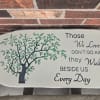 Concrete bench with green tree engraved.