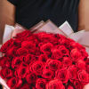 A beautiful round hand bouquet of 48 fresh red roses, expertly arranged