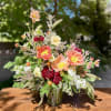 A sunlit celebration of color and texture, this arrangement bursts with vitality.