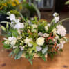 this arrangement is a sophisticated blend of white, cream, and peach, with