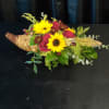 A beautiful Cornucopia with fall flowers perfect for a centerpiece for the