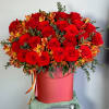A luxury flower arrangement of premium red garden roses and fiery orange