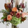 tall fall arrangement with orchids and magnolia