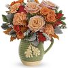 Teleflora&#039;s Rosy Autumn Bouquet is presented in a food- safe, glazed stoneware