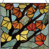 Stained glass panel with autumn leaves in shades of orange, available at
