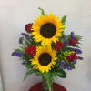 Beautiful bouquet with gorgeous sunflowers, red roses and purple statice. 