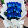 A captivating arrangement of fresh blue roses, elegantly wrapped and tied with