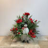 This festive holiday arrangement bursts with cheer, featuring a jolly snowman bobblehead