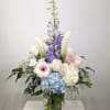 This tall sculptural bouquet of soft purple/blue delphinium, Calla lily and two