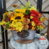 Bursting with fall cheer, this radiant autumnal arrangement arrives in a Pumpkin