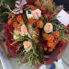 Peach and white roses with golden burnt orange and orange mums. Fall