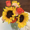 Sunflowers, orange roses and carnations in this modern fall blend.