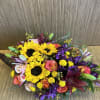 Thanksgiving centerpiece featuring an assortment of fall flowers arranged in a cornucopia.