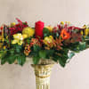 Thanksgiving centerpiece featuring an assortment of fall flowers arranged in a floral