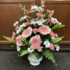 A gentle arrangement blend of soft pinks and whites displaying a graceful