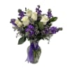 White roses, lavender stock and waxflower, arranged in a clear glass vase