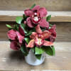 5-6 Cymbidium Orchids and hearty greens is a marble vase.  Perfect